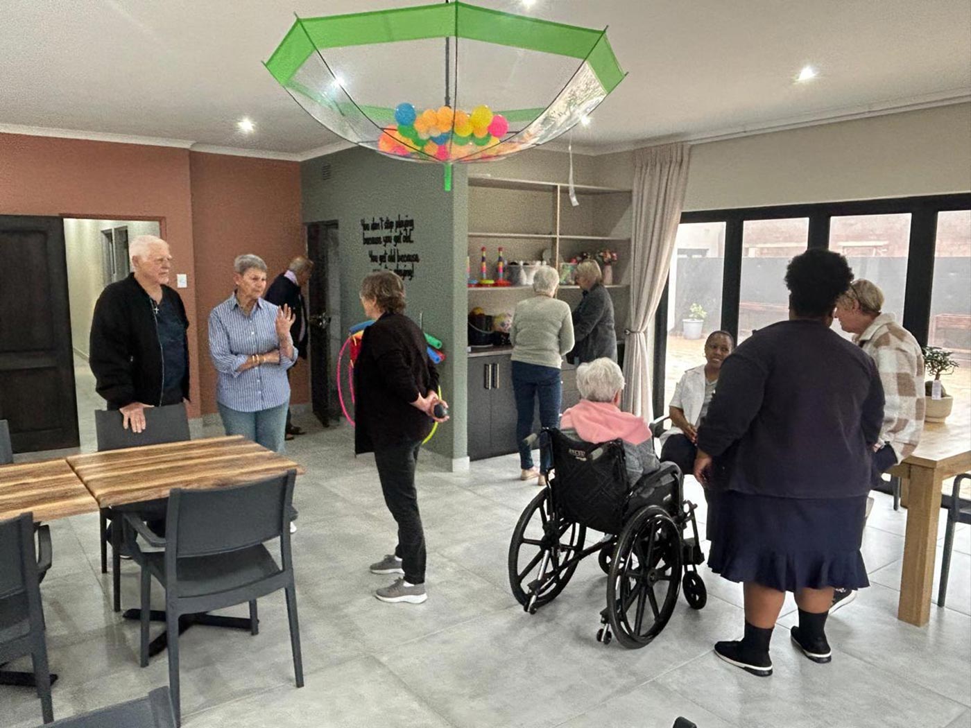 A gathering in the Home Angels day care centre, decorated for a celebration